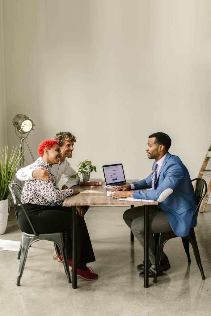 Financial advisor meeting with clients in a modern office